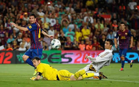 Cristiano Ronaldo sliding on his knees, while Lionel Messi beats Iker Casillas, in Barcelona vs Real Madrid
