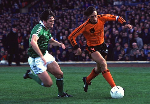 Johan Cruyff running and dribbling, while playing for the Netherlands National Team