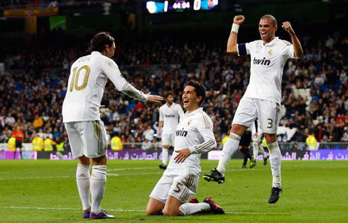 Nuri Sahin on his knees to Mesut Ozil, while Pepe jumps behind, in Real Madrid 2011-2012