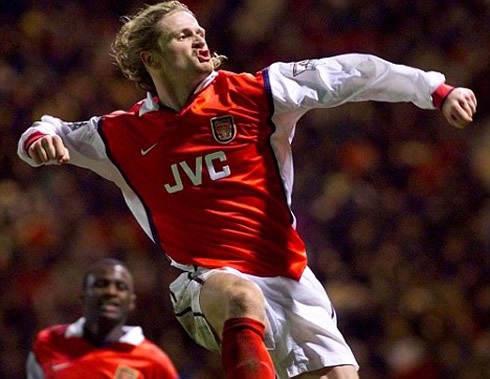 Emmanuel Petit celebrating a goal for Arsenal, while Patrick Vieira approaches from behind