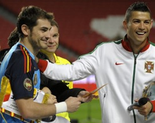 Cristiano Ronaldo laughing and saluting Casillas during a ceremony before a match between Portugal and Spain