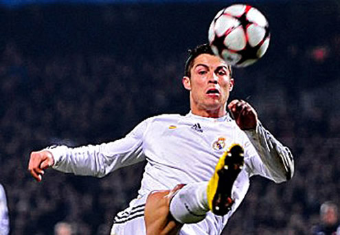 Cristiano Ronaldo stretches his right leg to attempt to get in touch with the ball