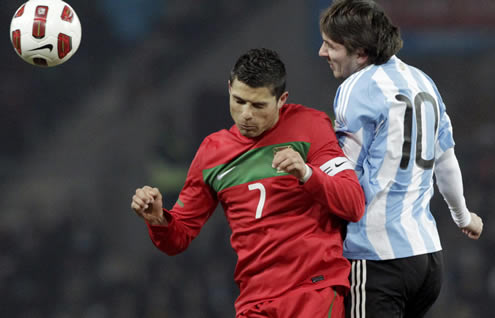 Cristiano Ronaldo fighting for the ball with Lionel Messi, in a Portugal vs Argentina match