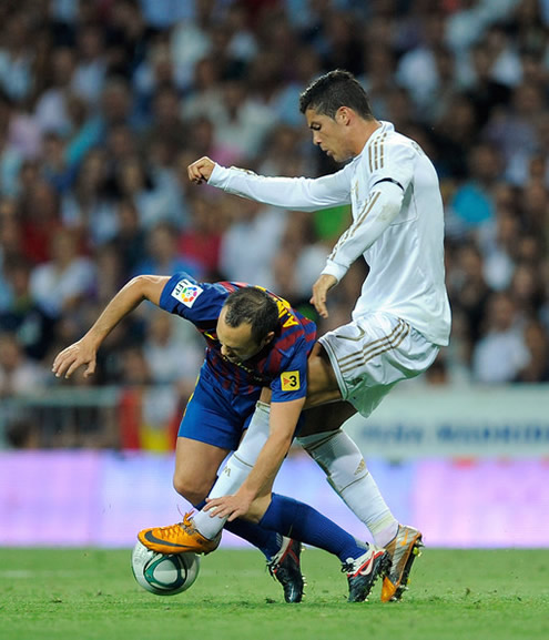 Cristiano Ronaldo stealing the ball to Andrés Iniesta