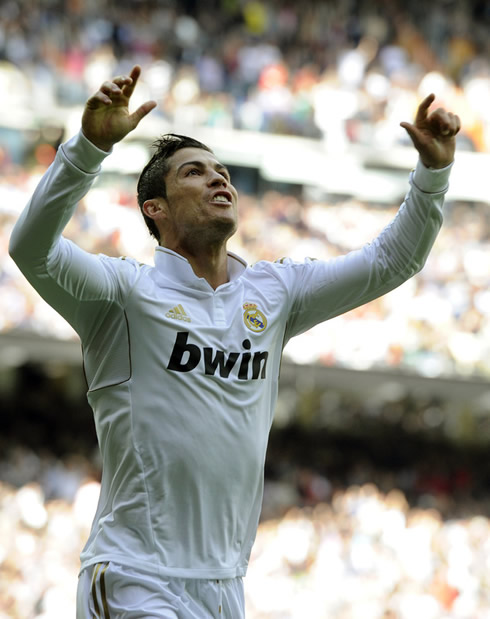 Cristiano Ronaldo with his arms raised, celebrating a goal for Real Madrid