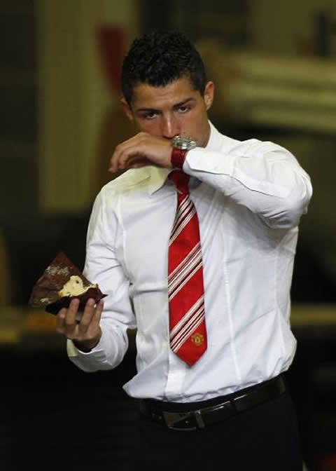 Cristiano Ronaldo fashion in a manchester united suit, with red tie