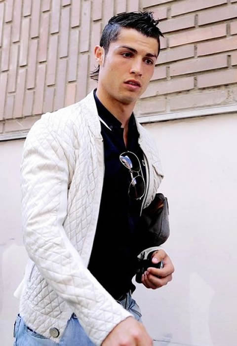 Cristiano Ronaldo fashion in a white jacket and black t-shirt, holding a purse