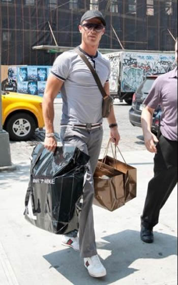 Cristiano Ronaldo fashion with cap and several bags on his hands