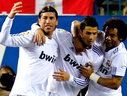 Cristiano Ronaldo, Sergio Ramos and Marcelo hugging each other in a Real Madrid goal celebration