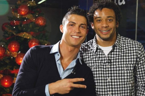 Cristiano Ronaldo doing the victory sign with his hand, with Marcelo next to him in Real Madrid christmas party