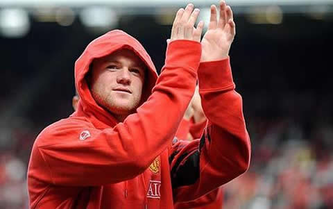 Wayne Rooney wearing a Manchester sweat shirt with the hood put on