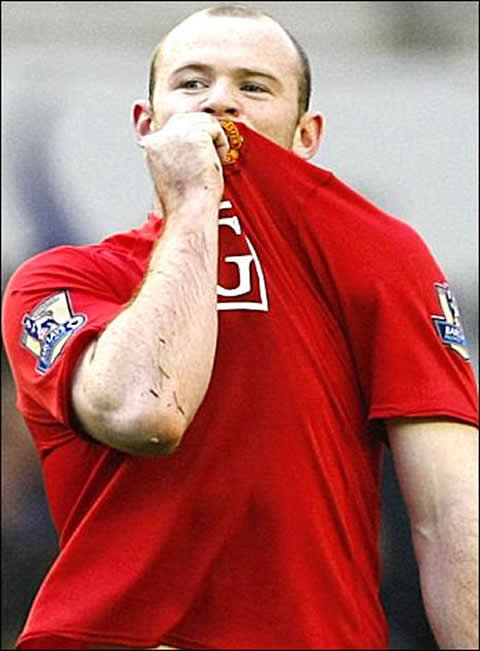 Wayne Rooney showing his love and dedication to the club, by kissing Manchester United jersey badge