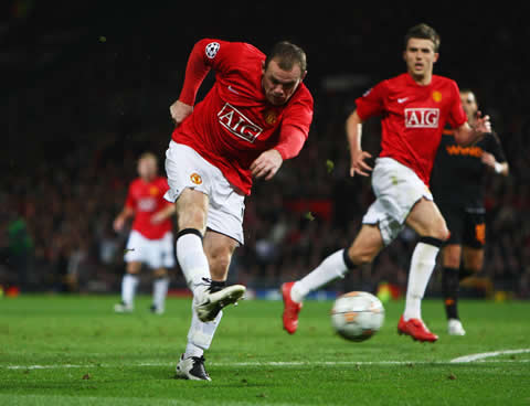 Wayne Rooney shooting the ball in a Manchester United game against AS Roma, in the UEFA Champions League