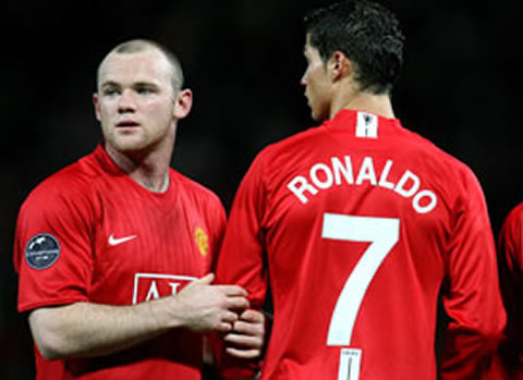 Wayne Rooney gently holding Cristiano Ronaldo arm
