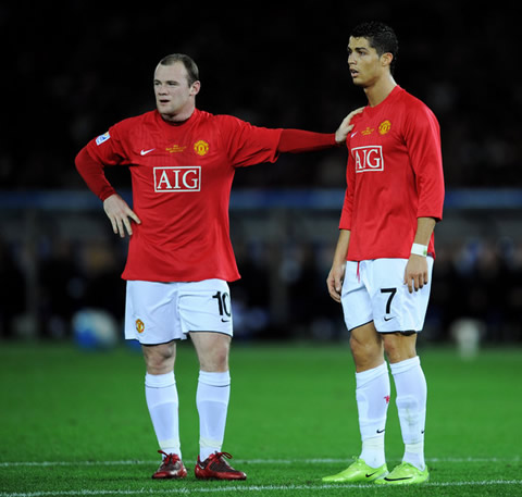 Wayne Rooney putting his hand on Cristiano Ronaldo's shoulder while discussing and chatting about something