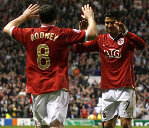Rooney and Ronaldo preparing to touch hands to celebrate another goal for Manchester United