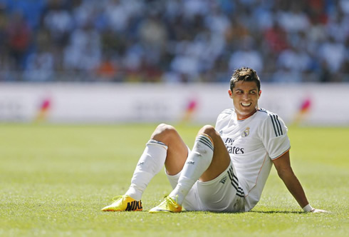 Cristiano Ronaldo grinding his teeth and sitting on the pitch, during a Real Madrid match in 2013-2014