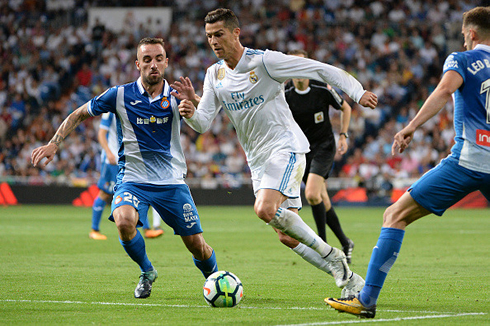 Cristiano Ronaldo dribbling two Espanyol opponents in their league clash in October of 2017