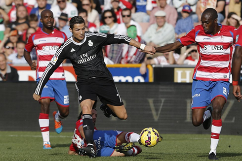 Cristiano Ronaldo jumping over a defender's sliding tackle