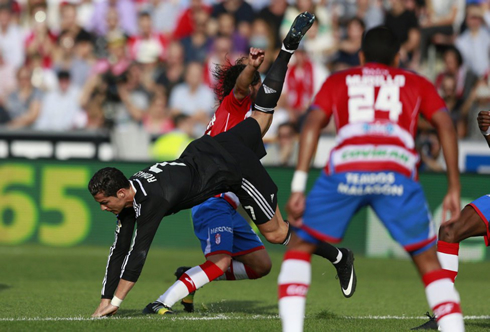 Cristiano Ronaldo falling down after clashing against a defender