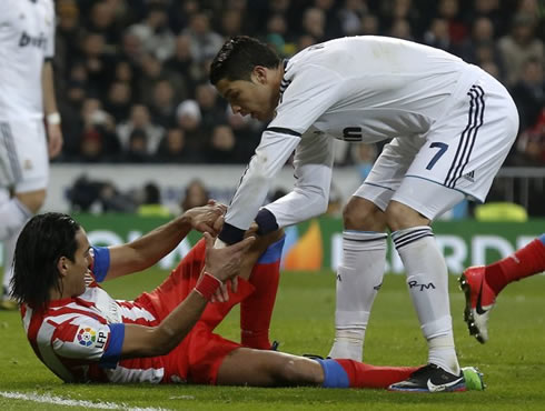 Cristiano Ronaldo reaching his hand to Radamel Falcao to help him standing, during Real Madrid vs Atletico Madrid for La Liga 2012-2013