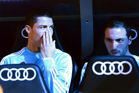 Cristiano Ronaldo telling a secret to Gonzalo Higuaín, while both players remain benched in the Clasico between Real Madrid and Barcelona, for La Liga 2013