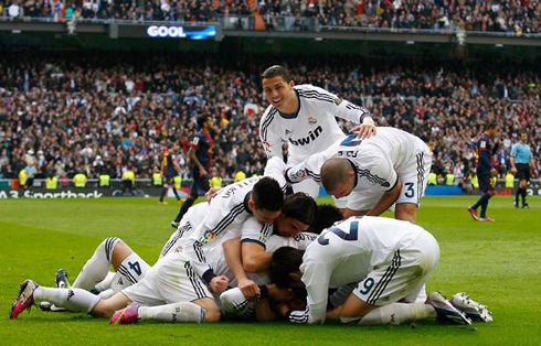 Cristiano Ronaldo smiling while every Real Madrid player piles up during the winning goal celebrations, in the match against Barcelona for the Spanish League 2012-2013