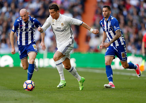 Cristiano Ronaldo racing between two defenders in a game for La Liga in 2017