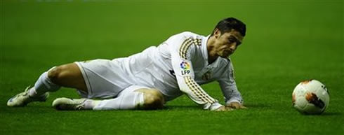 Cristiano Ronaldo goes to the ground but uses his arms to hold on