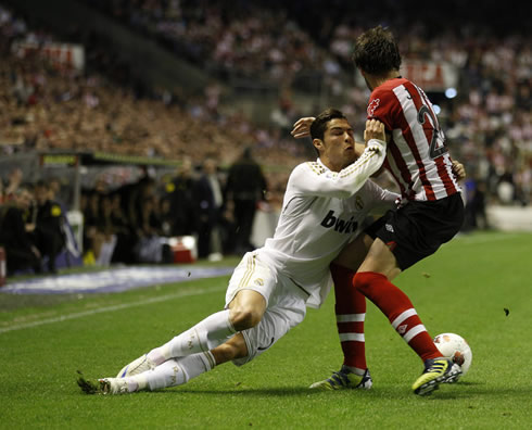 Cristiano Ronaldo falling down and holding to a defender, in a Real Madrid game against Athletic Bilbao in 2012
