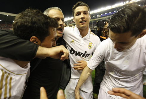 José Mourinho hugging Alvaro Arbeloa and Cristiano Ronaldo, with Callejón also trying to join the group