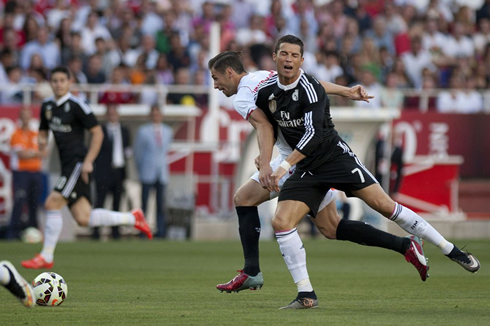 Cristiano Ronaldo closing his eyes after clashing against a Sevilla defender