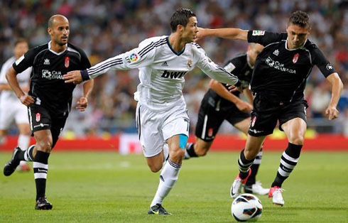 Cristiano Ronaldo making a run forward with his two arms open, in Real Madrid vs Granada for La Liga 2012/2013