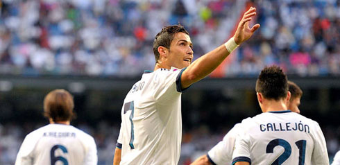 Cristiano Ronaldo raising his hand to make a gesture to the crowd, as he celebrates his first goal in La Liga 2012/2013 for Real Madrid