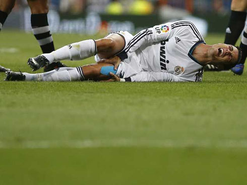 Cristiano Ronaldo grabbing his left leg as he cries on the pitch, after being injured in Real Madrid vs Granada, for La Liga 2012/2013
