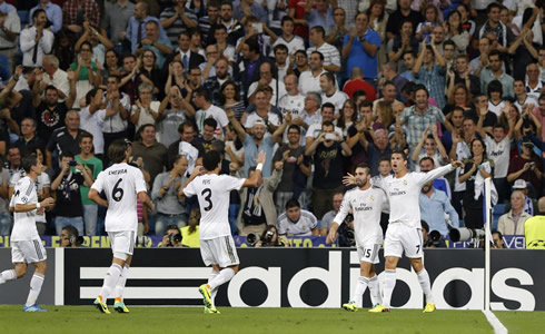 Cristiano Ronaldo welcomes his teammates to his goal celebration with his arms wide open and a big smile on his face