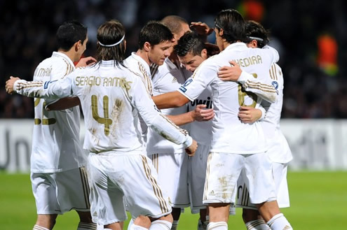 Several Real Madrid players hug each other and congratulate Cristiano Ronaldo for his goal