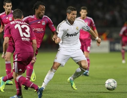Cristiano Ronaldo prepares to escape a Lyon defender
