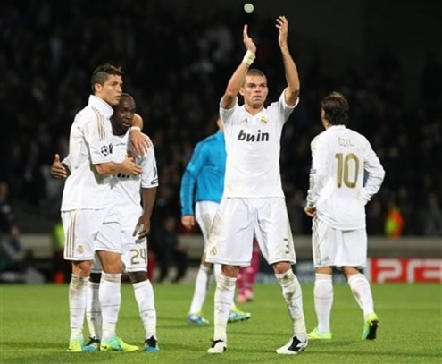 Cristiano Ronaldo hugs Lass Diarra, while Pepe claps the crowd