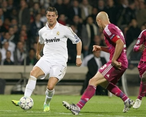 Cristiano Ronaldo attempting to dribble Cris, in Lyon vs Real Madrid