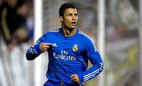 Cristiano Ronaldo pointing to Adidas logo on Real Madrid blue jersey, in La Liga 2013-2014