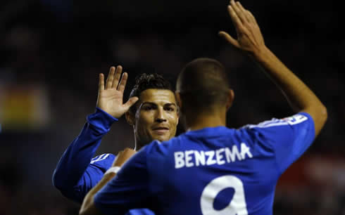 Cristiano Ronaldo giving a high five (hi5) to Karim Benzema