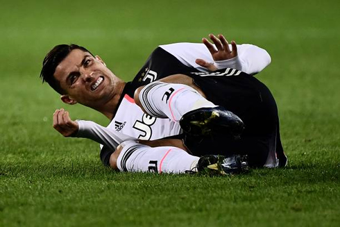 Cristiano Ronaldo on the ground and appearing to be in pain