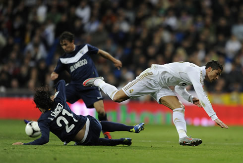 Cristiano Ronaldo being tackled by Sánchez