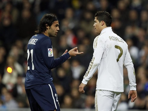 Cristiano Ronaldo having a quick chat with a Malaga defender