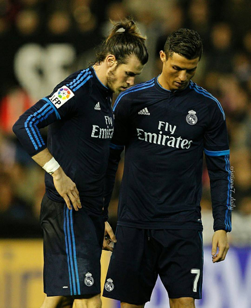 Bale and Ronaldo look down as they decide who takes the free-kick