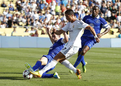 Cristiano Ronaldo being challenged on a left-foot strike, in Everton vs Real Madrid