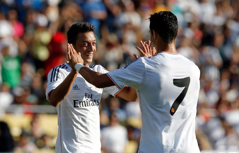 Mesut Ozil and Cristiano Ronaldo touching hands, in Real Madrid 2013-2014