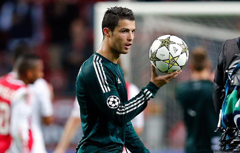 Cristiano Ronaldo holding the UEFA Champions League ball at the end of Ajax vs Real Madrid, after completing his first hat-trick in an European game, in 2012-2013