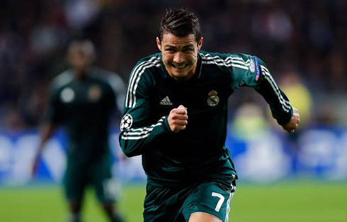Cristiano Ronaldo making an ugly face as he puts all his efforts in a sprint to chase the ball, in a Real Madrid green jersey, uniform and kit/shirt 2012-2013